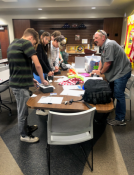 Volunteers are in front of a table